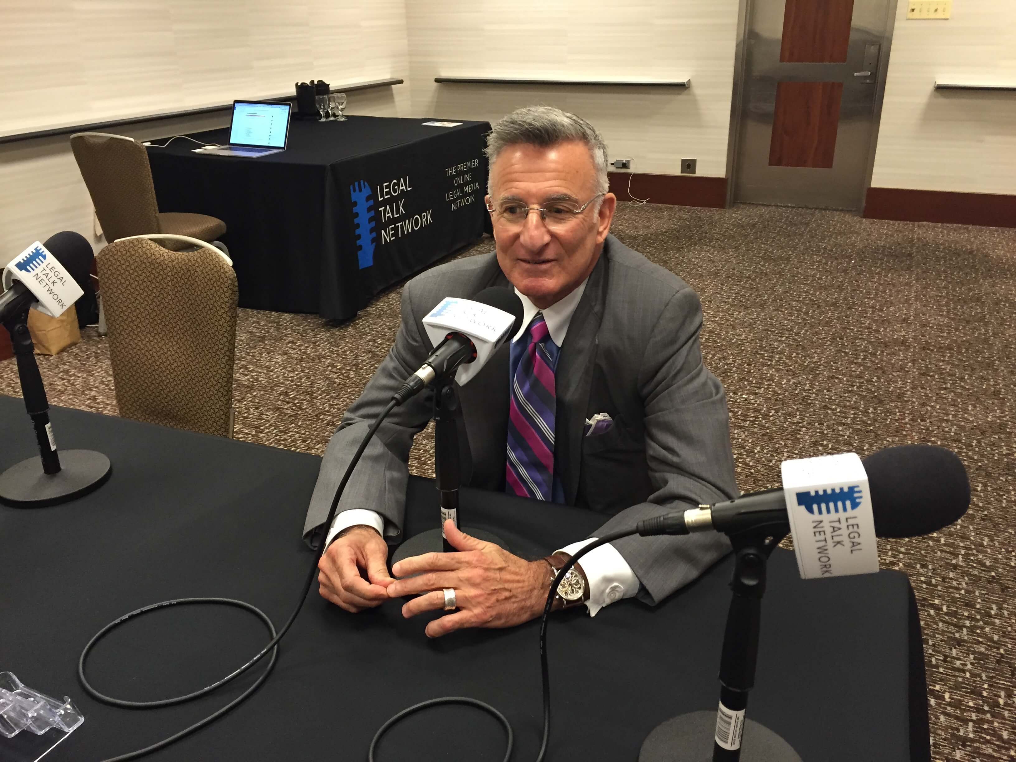 Joseph Yastrow in front of a microphone.